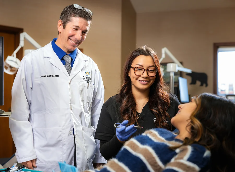Dr. Condie with teen patient and dental assistant