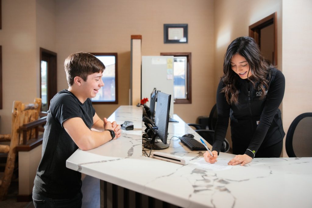 teen at the dental office front desk